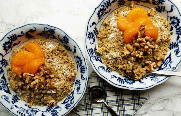 2 bowls of quinoa breakfast bowls with mandarin oranges, walnuts, and yogurt