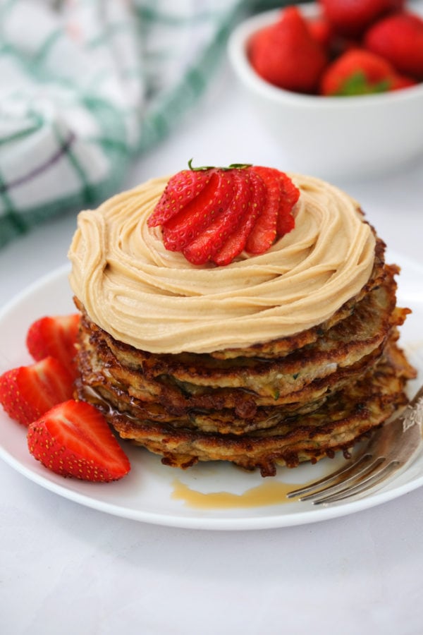stack of zucchini panckes with strawberry