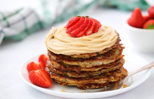 beautiful stack of zucchini pancakes plated on white plate