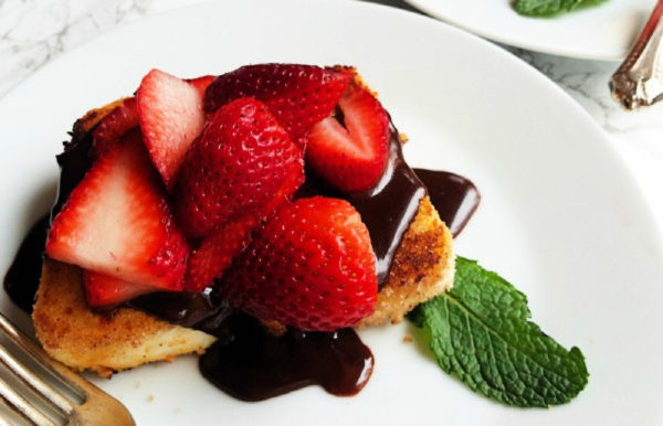 serving of ganache on fried angel cake with strawberries