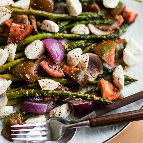 Close up of Pesto Asparagus Caprese Salad on white plate