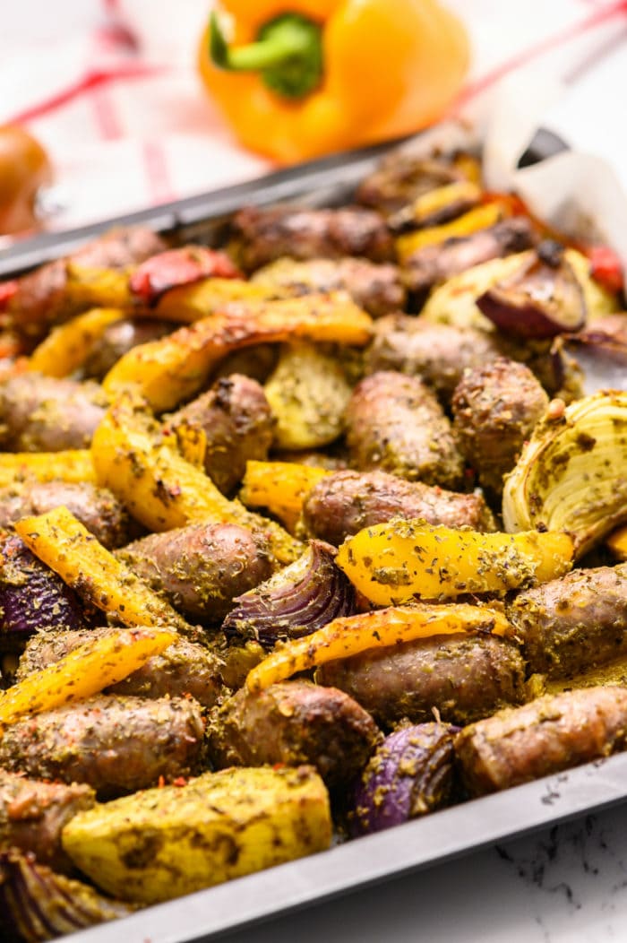 a sheet pan of brats and mixed peppers