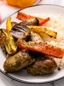 brats and peppers served on white rice