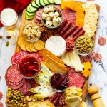 wood board of meat and cheese charcuterie with olives