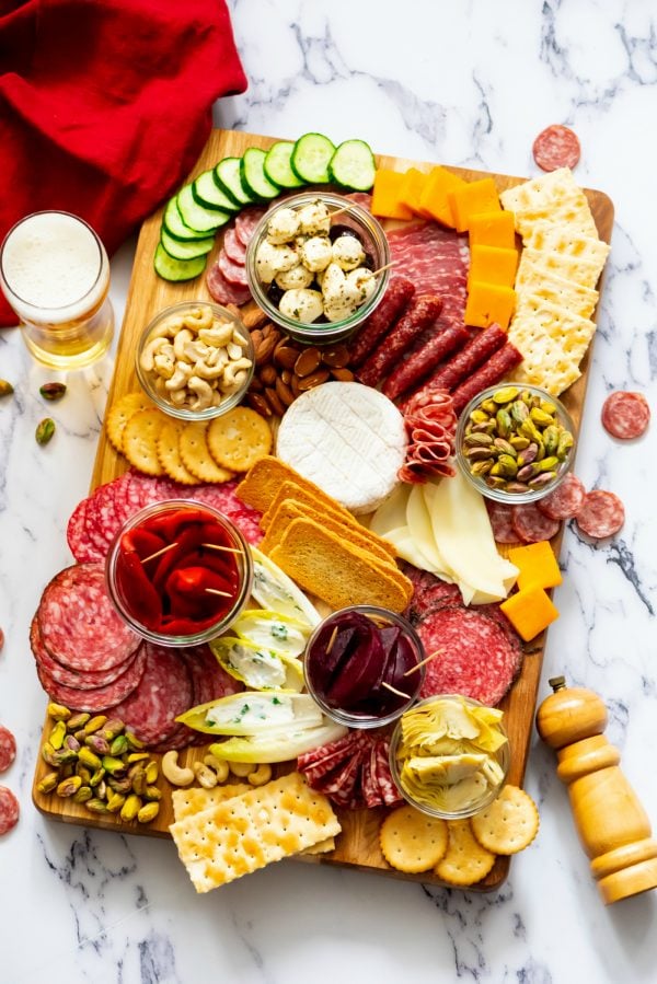 wood board of meat and cheese charcuterie with olives