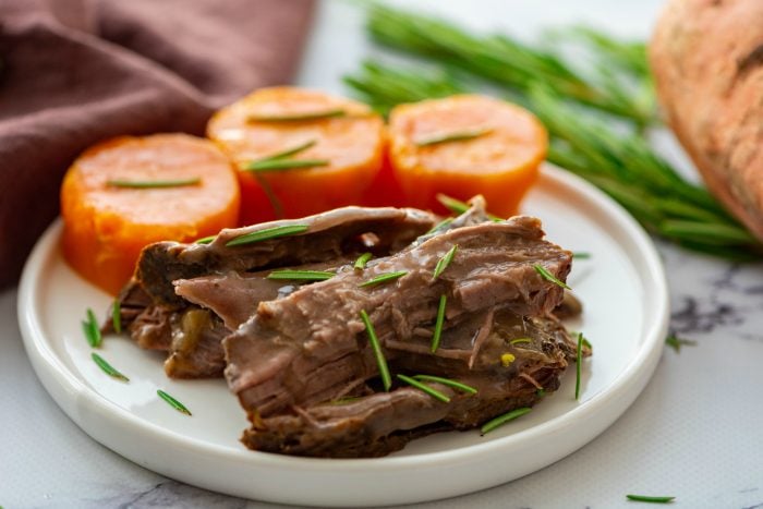 roast beef with sweet potatoes on a plate