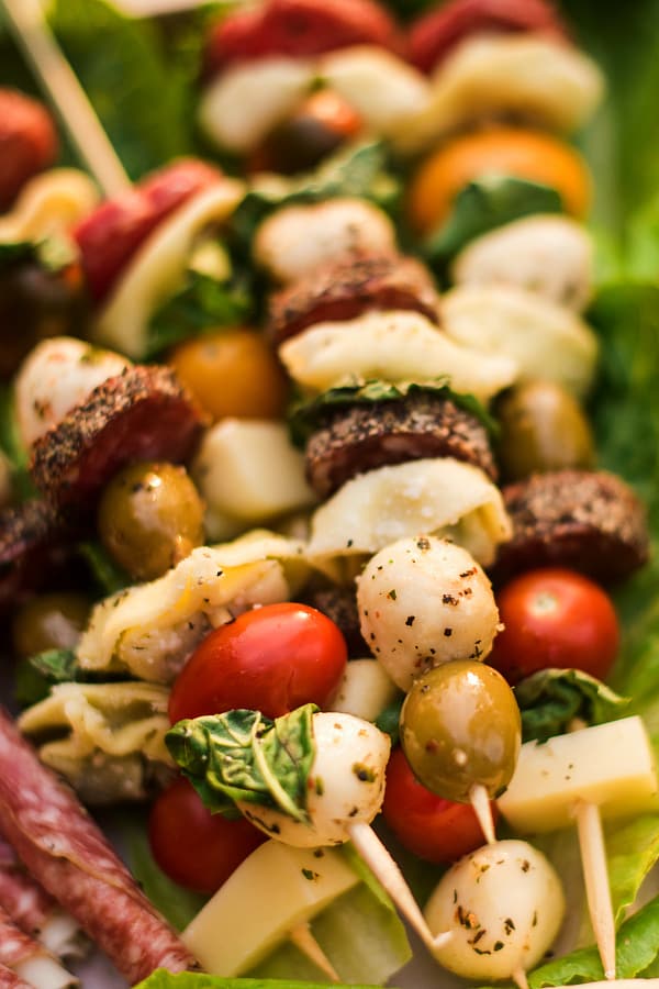 Make this Tortellini Sausage Skewers Appetizer for your next dinner party, game day party, potluck, or tailgate party! Add to a giant charcuterie board! #tortelliniskewers #charcuterie Tortellini Sausage Skewers Appetizer - on charcuterie board