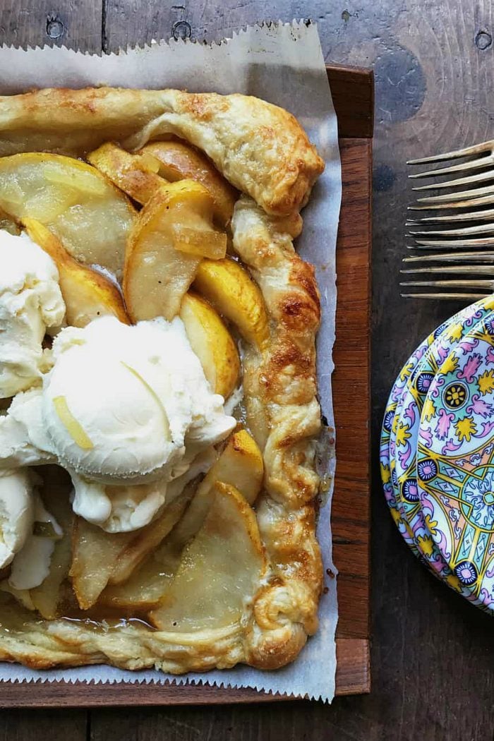 square puff pastry with pear on parchment paper