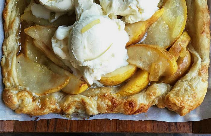 puff pastry baked with sliced pear, lemon, and ginger, served with vanilla ice cream