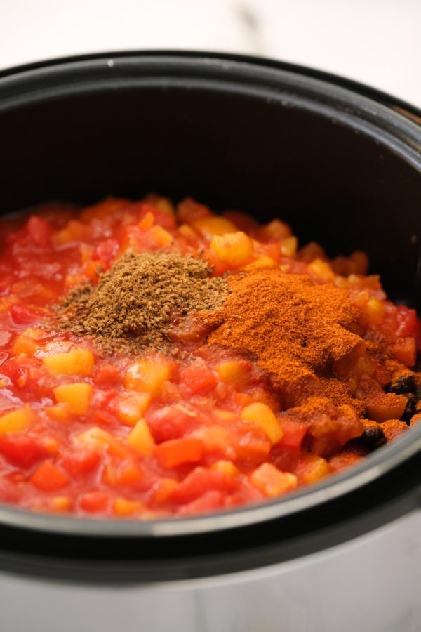 adding spices to Instant Pot Mango Chicken Chili