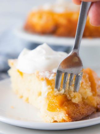 taking a bite of cake with fork (peach cake)