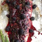 a baked fillet of salmon with homemade blackberry sauce