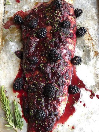 a baked fillet of salmon with homemade blackberry sauce