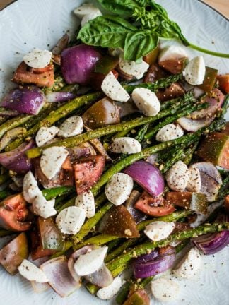 Pesto Asparagus Caprese Salad Recipe with mozzarella cheese, red onions, and tomatoes