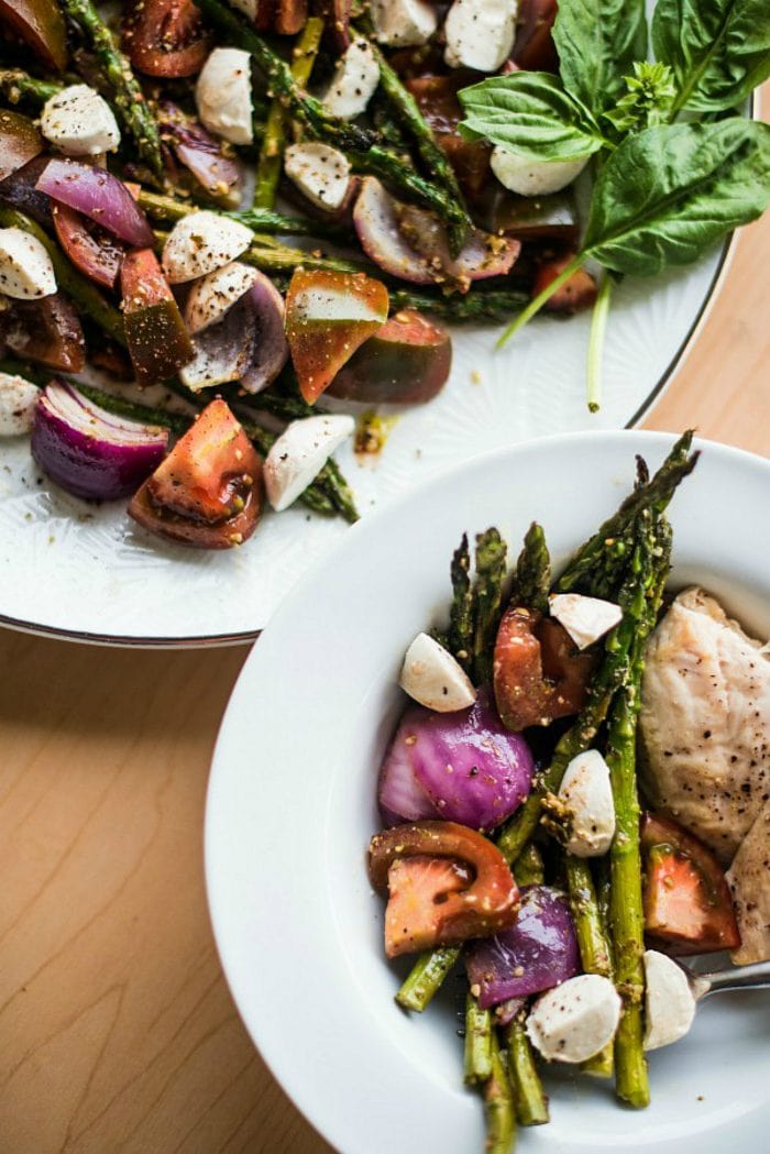 a side plate of Pesto Asparagus Caprese Salad Recipe with chicken breast
