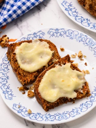 2 slices of carrot cake spread with cream cheese frosting