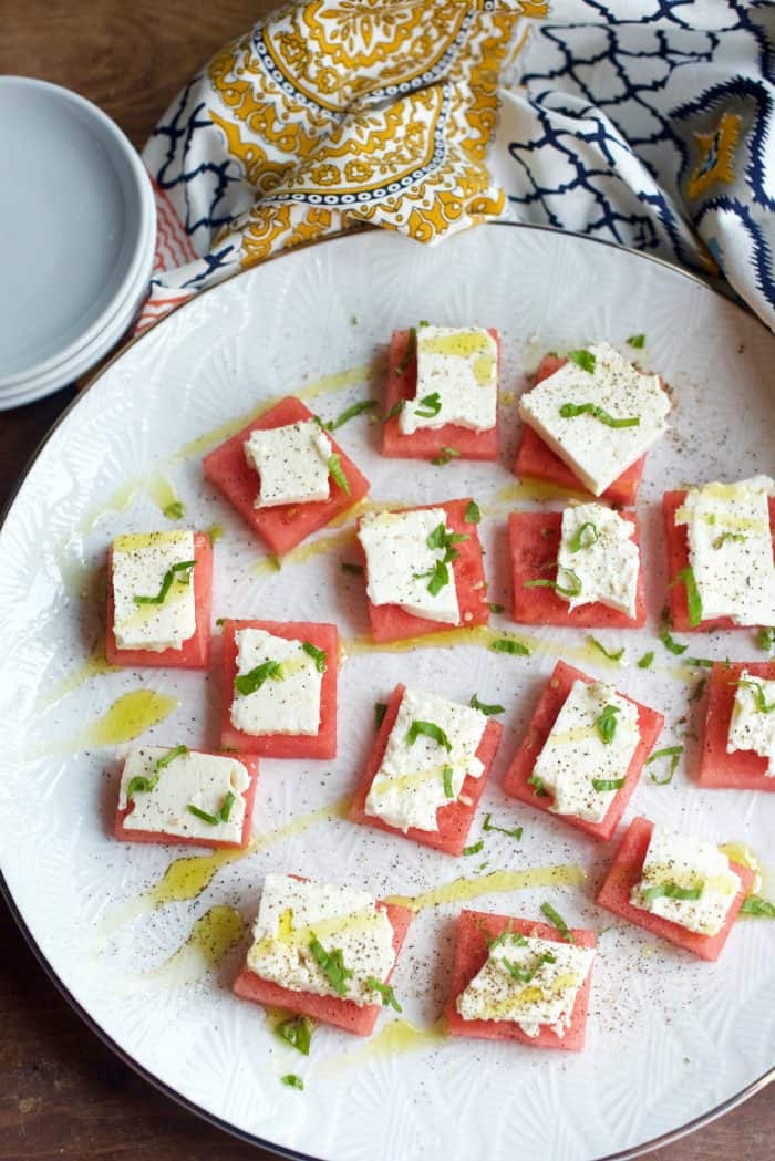 white plate of Watermelon Feta Bites Appetizer with drizzle
