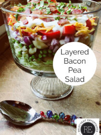 layered bacon pea salad in glass bowl