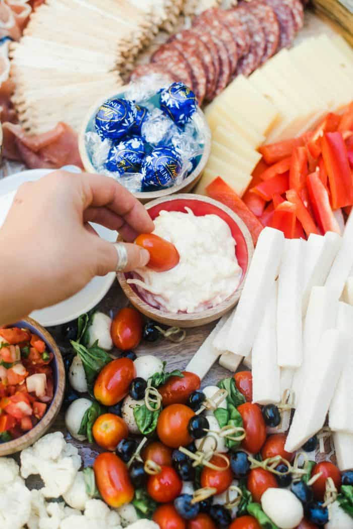 dipping Jarlsberg dip on July 4th Charcuterie Board