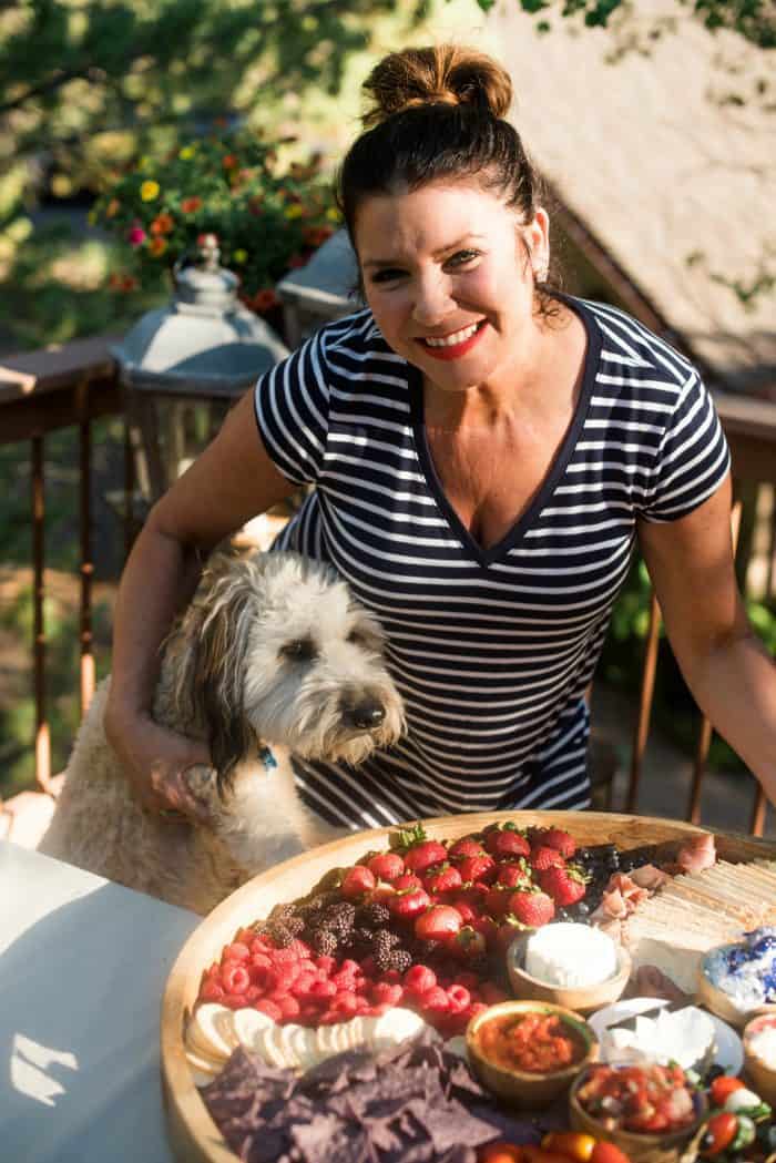 woman holding a Red, White, Blue Epic July 4th Charcuterie Board