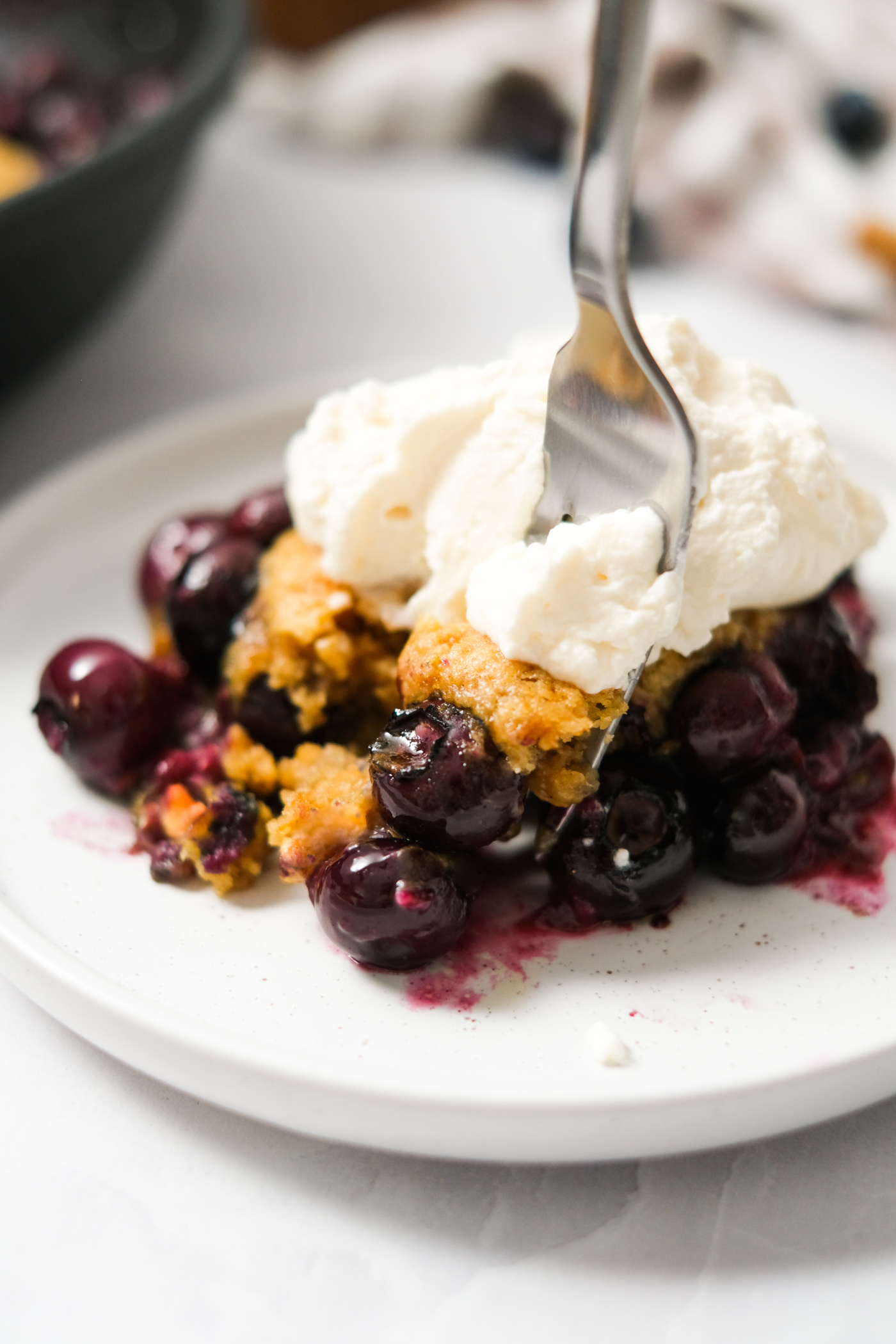 taking a bite of cobbler