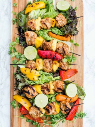 wood platter of Pineapple Mango Grilled Chicken Skewers