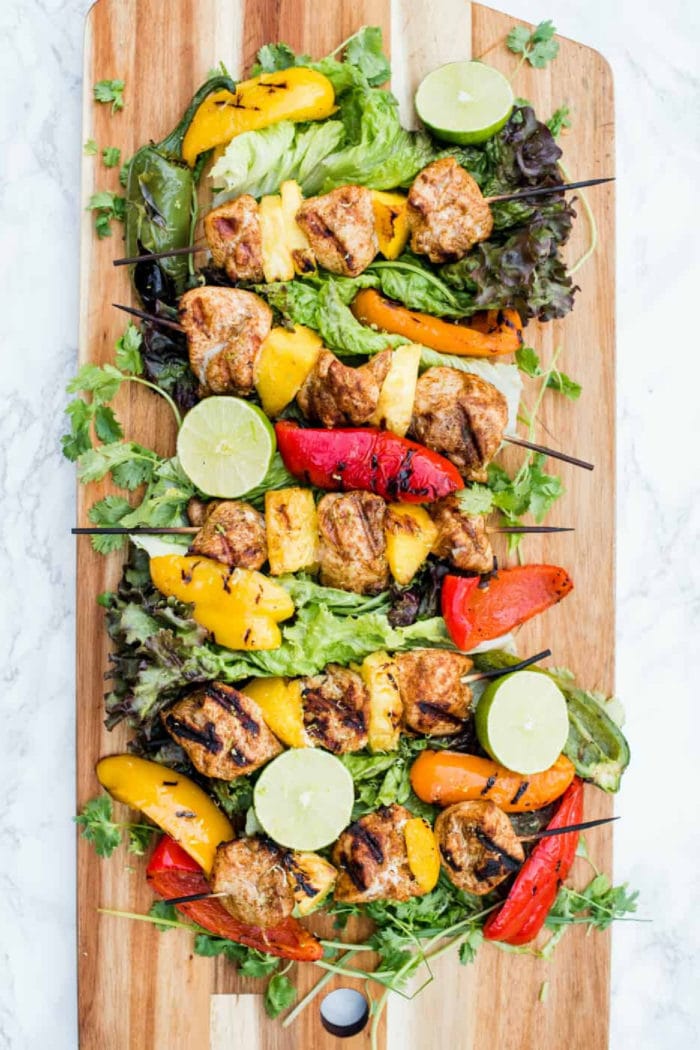 wood platter of Pineapple Mango Grilled Chicken Skewers