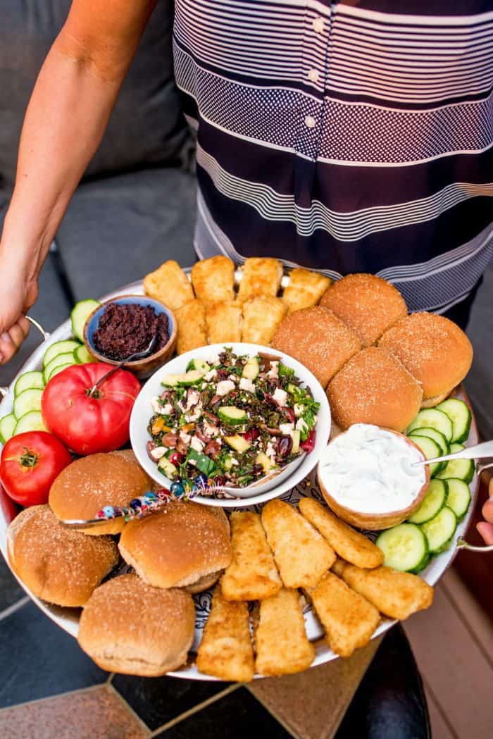 holding a Mediterranean Fish Burger Dinner Board