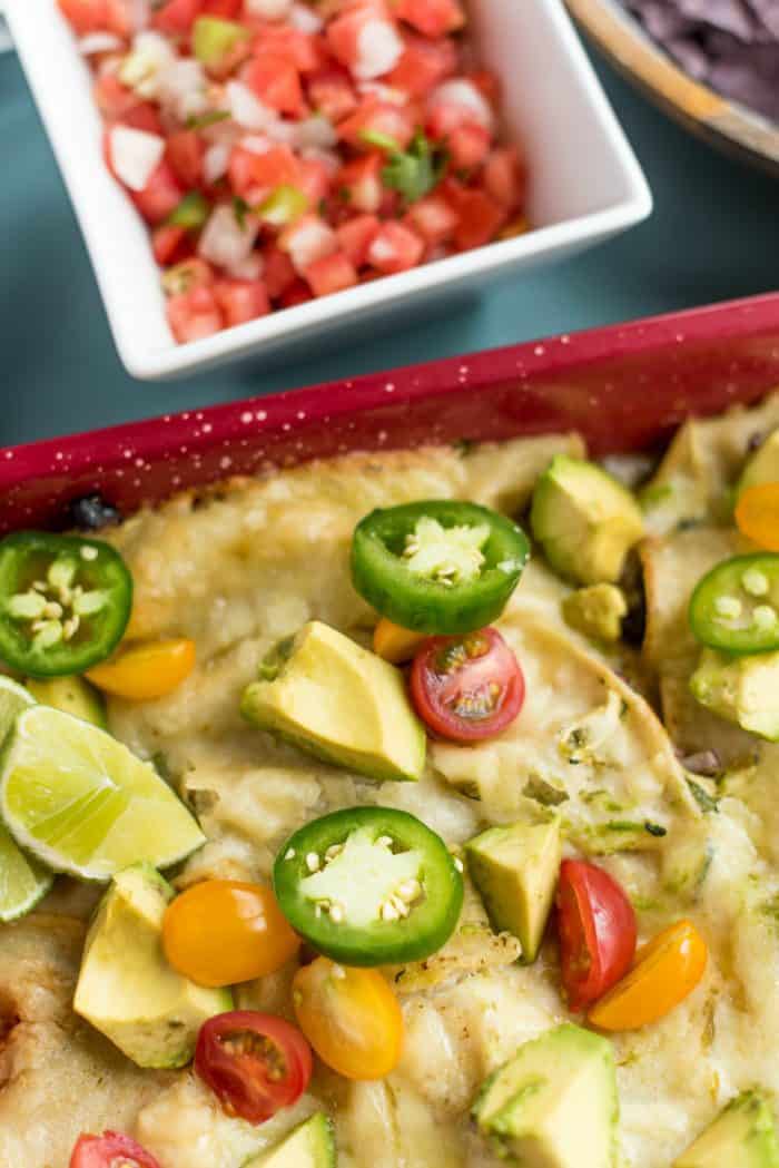 SUMMER Zucchini Cheese Enchiladas Verde Recipe garnished with avocado