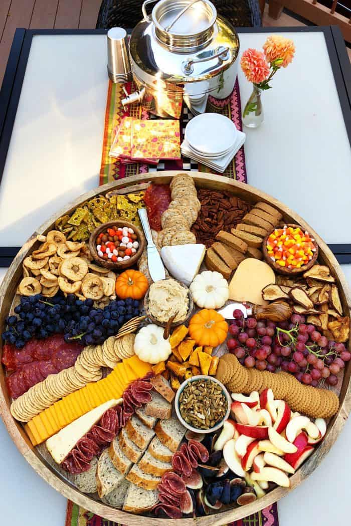 outside setup of Fall Epic Charcuterie Board with beverage and napkins