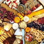 beautiful fall colors on a round charcuterie board with food