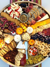 beautiful fall colors on a round charcuterie board with food