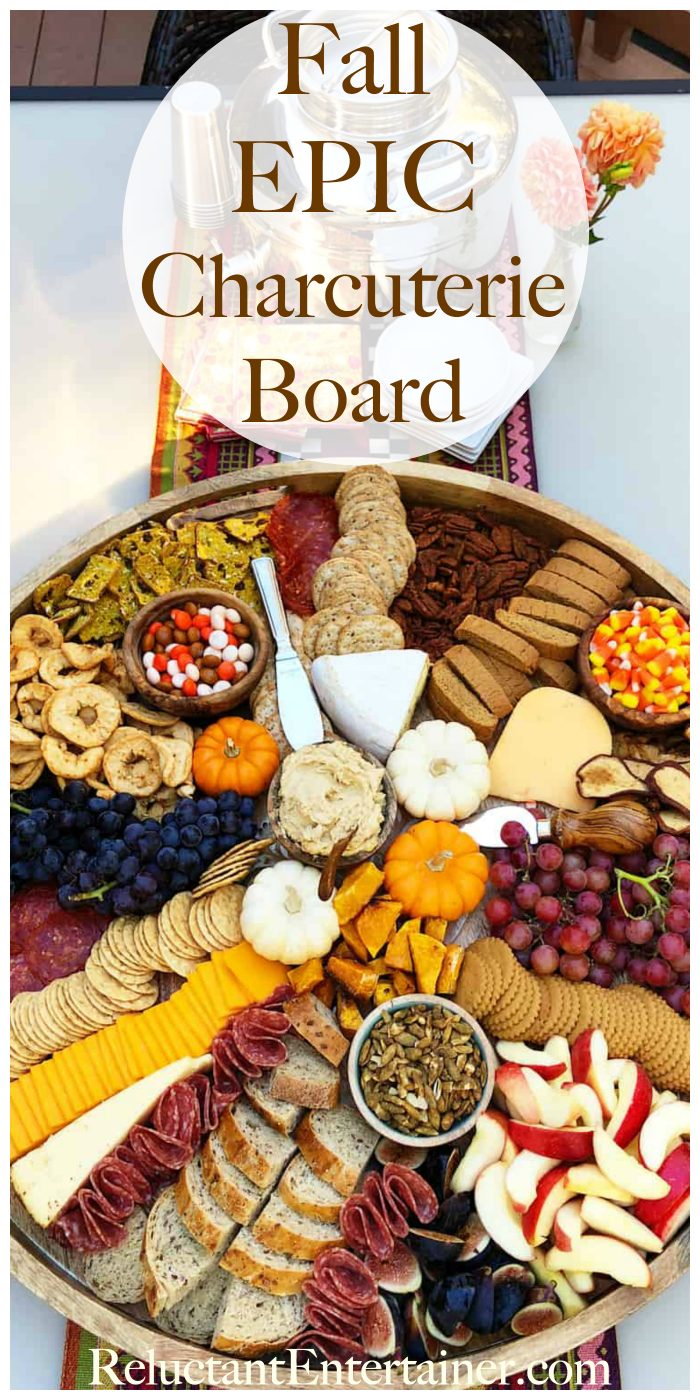 beautiful round board with fall charcuterie foods (and small pumpkins for garnish)