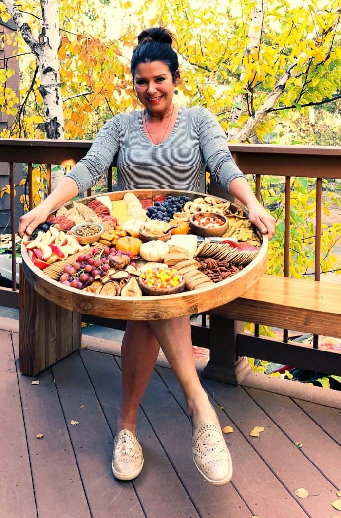 woman holding an Epic Charcuterie Board