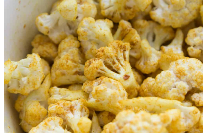 stirring in the seasoning to cauliflower