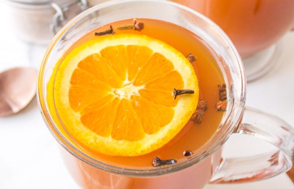 a cup of hot tea with orange