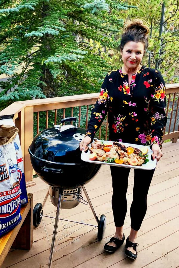 woman holding a platter of cornish game hens