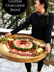 woman holding Epic Shrimp Cocktail Charcuterie Board