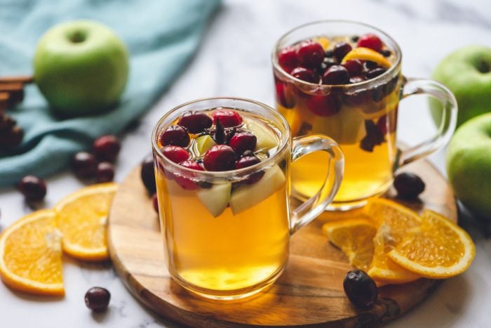 2 clear mugs with mulled cider