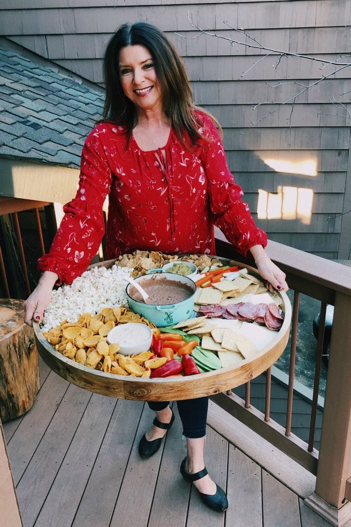 woman holding a round game day board