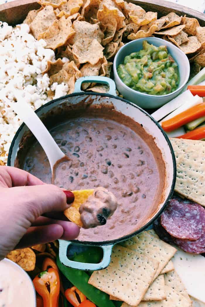 taking a bite of- black bean dip