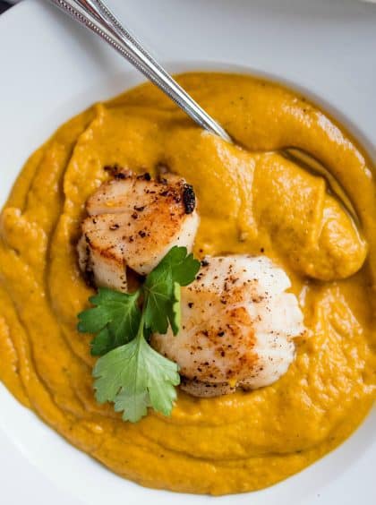 elegant bowl of butternut squash soup with seared scallops