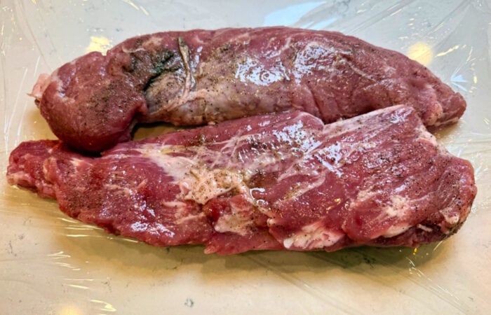 adding oil, salt, pepper to pork