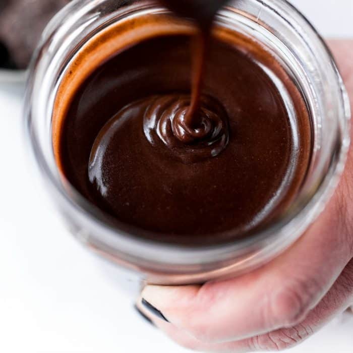 pouring Homemade Chocolate Sauce in a jar