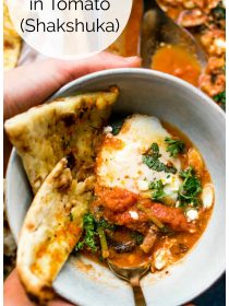a bowl of Eggs Poached in Tomato (Shakshuka) with pita bread