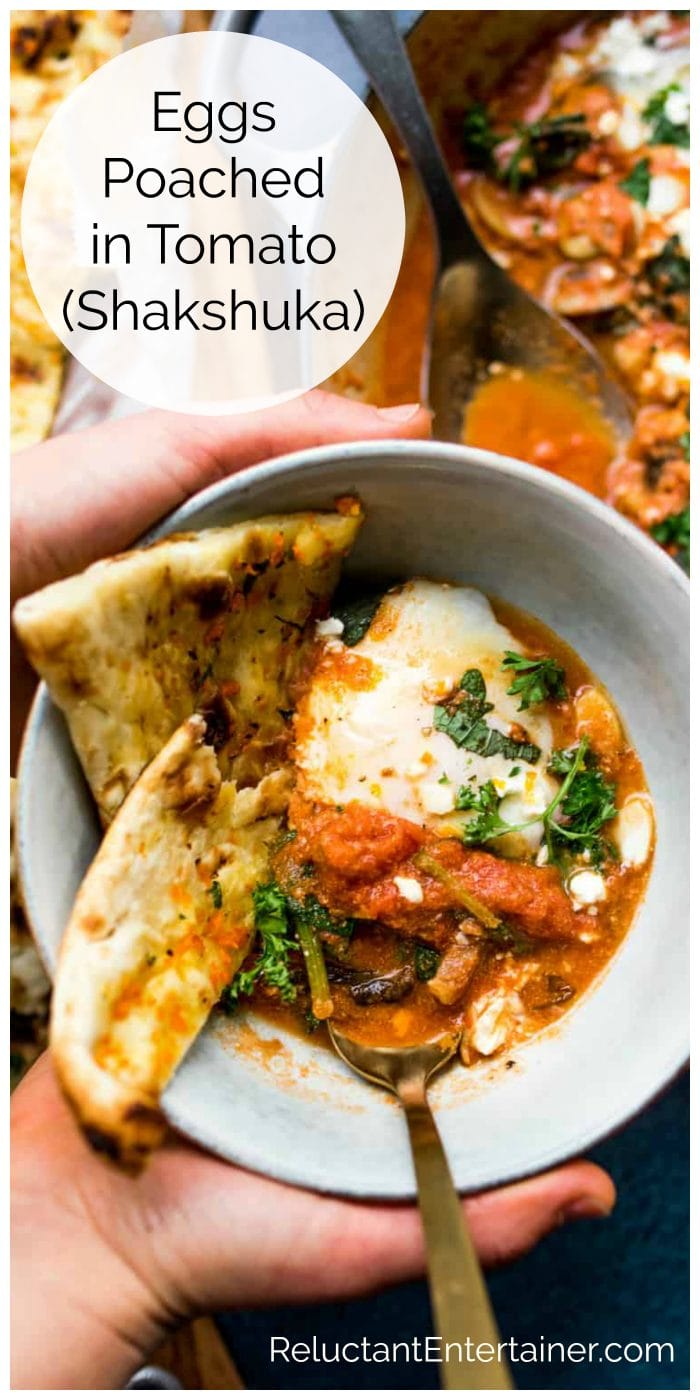 a bowl of Eggs Poached in Tomato (Shakshuka) with pita bread