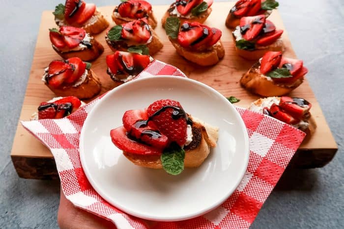 A Strawberry and Goat Cheese Bruschetta on a white plate