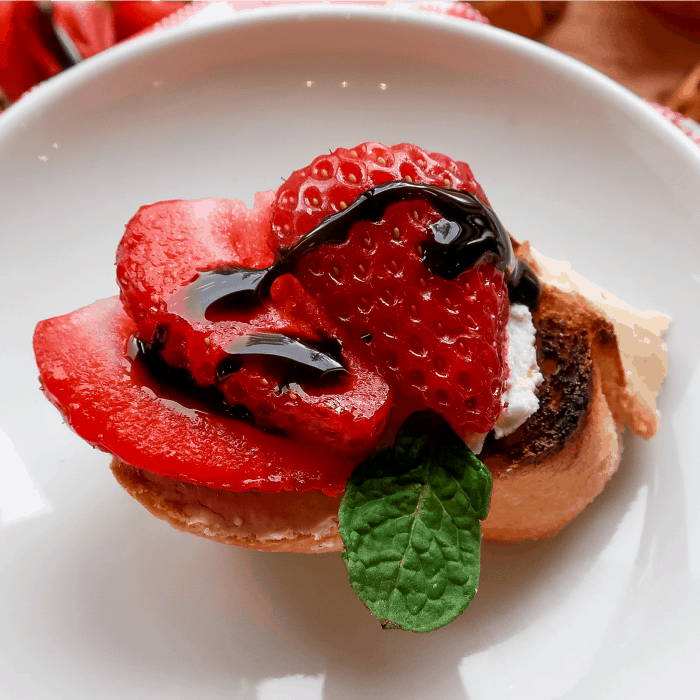 Close up Strawberry Bruschetta with Goat Cheese and balsamic drizzle