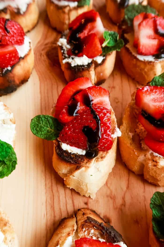 a platter of Strawberry Bruschetta with Goat Cheese with balsamic and mint