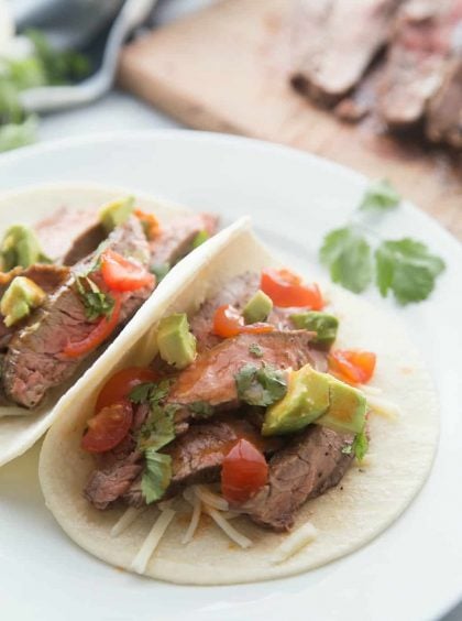 a plate of 2 tacos with flank steak